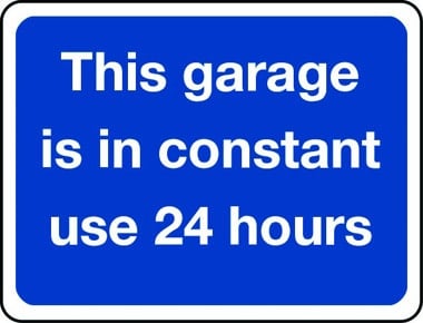 This garage is in constant use 24 hours a day sign