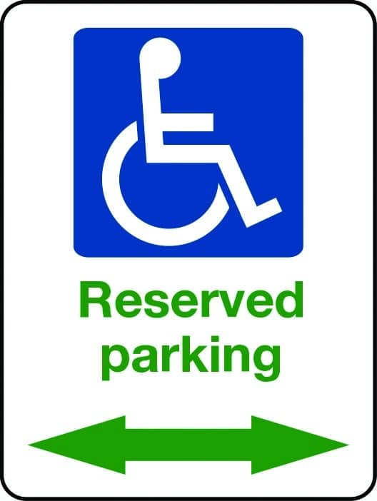 Reserved parking sign with green arrows and wheelchair