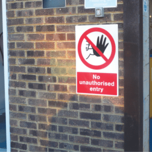 Prohibition - No Unauthorised Entry Sign on a brick wall