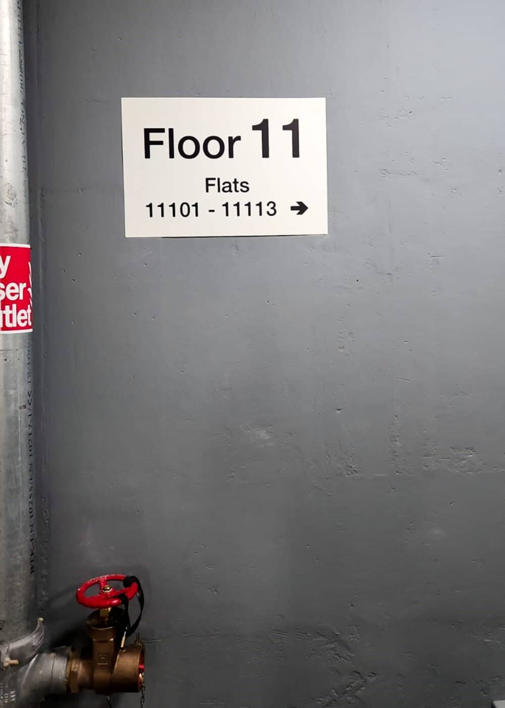 Wayfinding Signage on Floor 11,directing towards flats 11101- 11113 by a fire escape