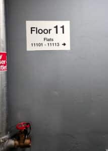 Wayfinding Signage on Floor 11,directing towards flats 11101- 11113 by a fire escape